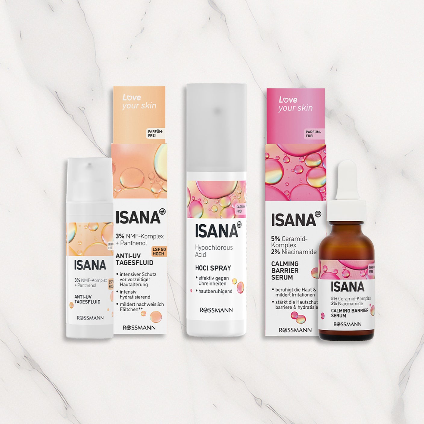 ISANA Hautpflegeprodukte Love your skin mit Anti-UV Tagesfluid, HOCl Spray und Calming Barrier Serum auf hellem Marmorhintergrund