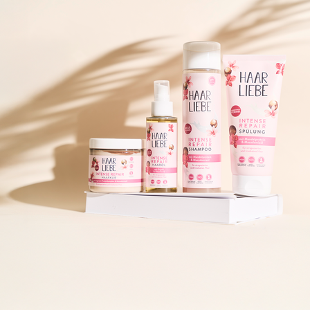 Eine Aufreihung der Haarliebe Produkte mit beigem Hintergrund